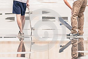 Handsome guys with skateboard at freestyle park outdoors