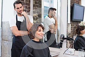 Handsome hair stylist with client