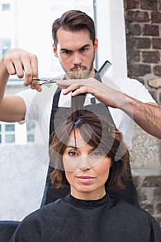 Handsome hair stylist with client