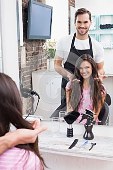 Handsome hair stylist with client