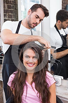 Handsome hair stylist with client