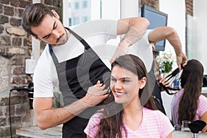 Handsome hair stylist with client