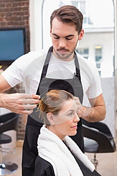 Handsome hair stylist with client