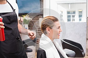 Handsome hair stylist with client