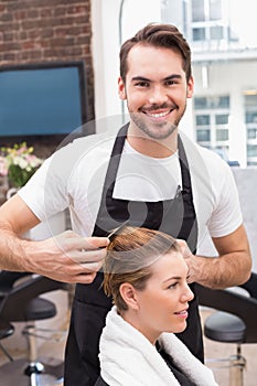 Handsome hair stylist with client