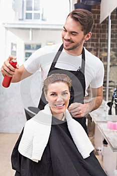 Handsome hair stylist with client