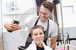 Handsome hair stylist with client