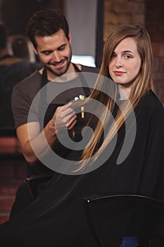 Handsome hair stylist with client