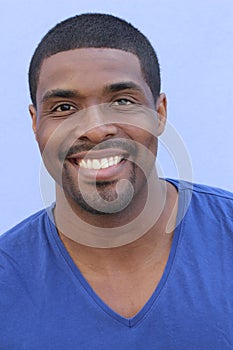 Handsome happy African man with a perfect white smile isolated on a blue background