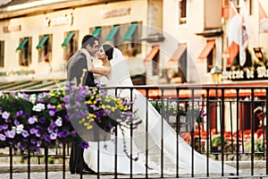 Handsome happy bride and beautiful sensual groom at romantic bridge in france closeup