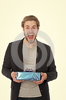 Handsome happy businessman holding blue gift box