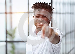Handsome happy young man pointing at camera