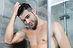 Young man taking shower