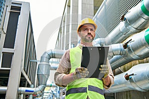 handsome hardworking professional in safety helmet