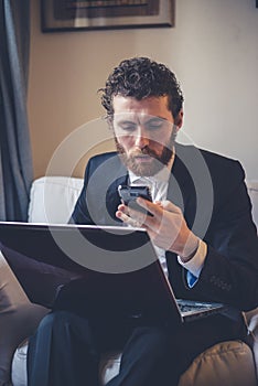 Handsome hipster elegant man using laptop