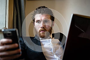 Handsome hipster elegant man using laptop