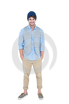 Handsome hipster with hands in pocket looking at camera