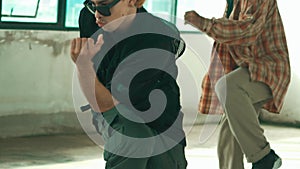 Handsome hipster practicing break dance with multicultural friends. hiphop.