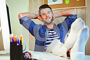 Handsome hipster working at desk