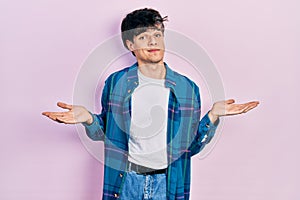 Handsome hipster young man wearing casual white t shirt and vintage shirt clueless and confused expression with arms and hands