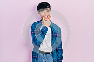 Handsome hipster young man wearing casual white t shirt and vintage shirt looking confident at the camera smiling with crossed