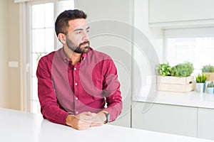 Handsome hispanic business man looking to side, relax profile pose with natural face with confident smile