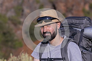 Handsome hispanic male trekker looking at camera