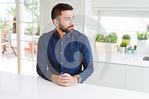 Handsome hispanic man looking to side, relax profile pose with natural face with confident smile