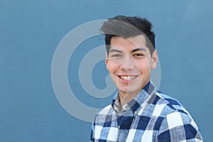 Handsome hispanic man with a perfect white smile isolated on a blue background