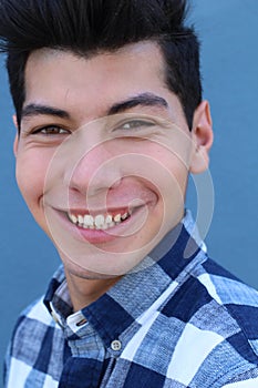 Handsome hispanic man with a perfect white smile isolated on a blue background