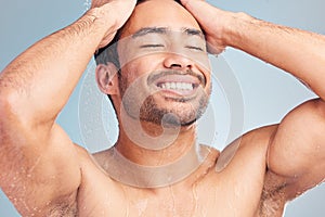 Handsome hispanic man in the shower. Young man enjoying a shower in a studio. Man washing his body in the shower. Young