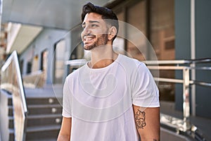 Handsome hispanic man smiling happy outdoors