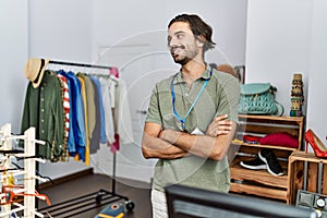 Handsome hispanic man working as shop assistance at retail shop