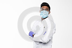 Handsome Indian Male Doctor with surgical or safety health Mask on. standing isolated over white background