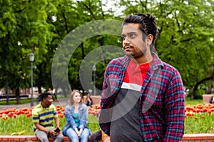 Handsome indian man posing outdoors at park
