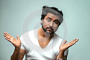 Handsome Indian man showing indifference to the problem, situation