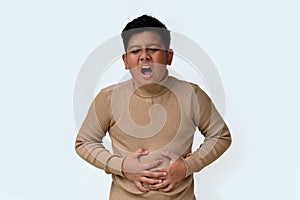 handsome indonesian boy with stomachache expression photo
