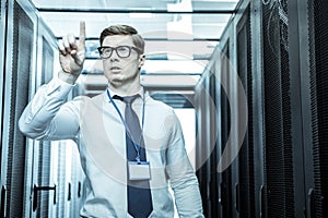Handsome investigator in eyeglasses analyzing the problem photo