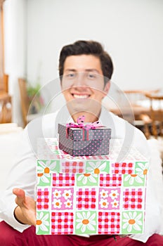 Handsome joyful young man holding Christmas