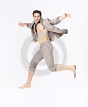 Handsome jumping man on suit isolated on a white background