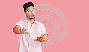 Handsome latin american young man wearing casual summer shirt doing stop gesture with hands palms, angry and frustration