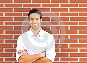 Handsome latin guy in front of a brick wall