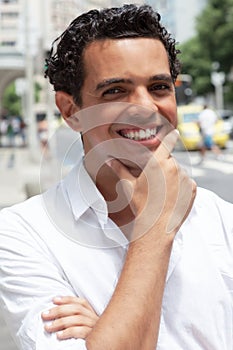 Handsome latin guy with a toothy smile in the city