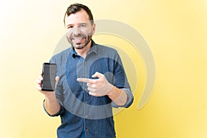 Handsome Latin Man Showing Mobile Phone