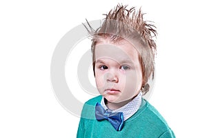 Handsome little boy in blue bow tie and green sweater isolated on white background