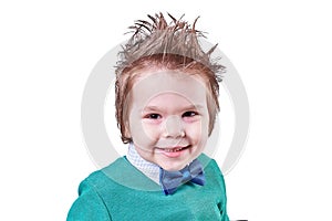 Handsome little boy, in blue bow tie and green sweater, smiling, isolated on white background