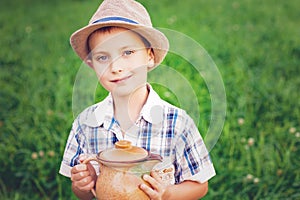 Handsome little boy with jug