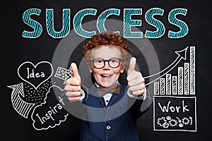 Handsome little boy showing thumbs up. Business idea, education, start-up and success concept