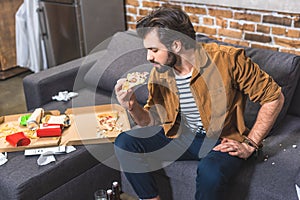 handsome loner eating pizza photo