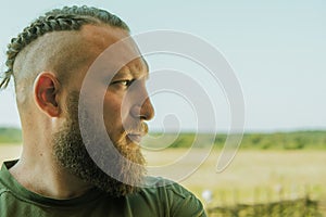 Handsome long-bearded man. Man with a beard profile. Freedom, space, air, biker, lifestyle